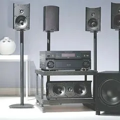 A full Definitive Technology ProMonitor setup with an AV receiver. This shows how you can build a high-performance system with satellite speakers on stands, a dedicated center channel, and a matching subwoofer for a cohesive look and sound.