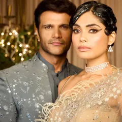 A powerful couple shot showcasing the vintage hair and makeup. The style holds its own and creates a strong fashion statement, perfect for a themed party or an editorial shoot.