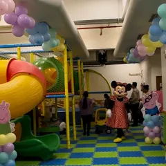 Imagine the look on your child's face when their favorite character shows up to the party. Here, Minnie Mouse makes a surprise visit during a birthday celebration in our play zone, complete with colorful balloon decorations.