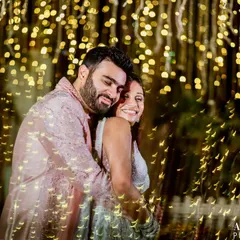 Playing with light to create something magical. This portrait uses creative lighting techniques to frame the couple in a cascade of golden bokeh, turning a simple embrace into a piece of art.