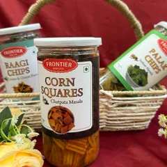 For our wedding hampers, we can include a variety of gourmet snacks like these jars of ragi chips, corn squares, and palak chips.