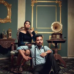 A stylish portrait from our vintage series, with the couple posed in a richly decorated room. The composition and mood are designed to feel like a still from a classic film.