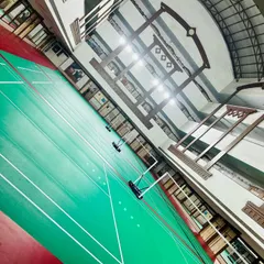 This angled shot showcases the scale of our facility. The excellent overhead lighting ensures optimal visibility during fast-paced evening sessions.