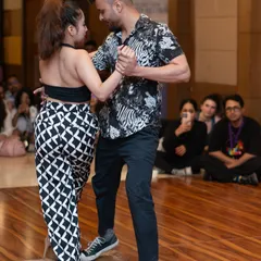 This image captures the intricate footwork and partner connection of Riya and Ravi's Kizomba routine. We focus on musicality and precision in our performance coaching.