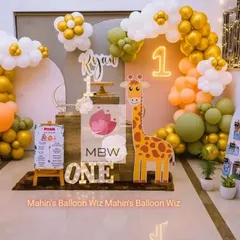 Another angle of the modern giraffe-themed first birthday, showcasing the full balloon arch and custom props that bring the celebration to life.