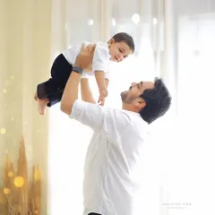 A classic father and son moment. Lifting your child up in the air always results in the biggest smiles and creates a memory of pure joy and connection.