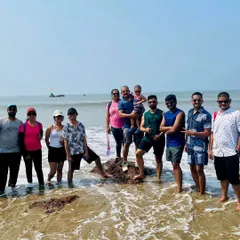 Having fun in the waves at Gokarna. Our beach treks are a perfect mix of adventure and relaxation.