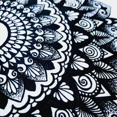 A close up view of the detailed patterns in my mandala art. I use fine-tipped pens to create the delicate lines, dots, and swirls.