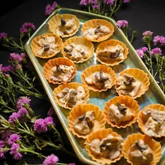 A tray of Creamy Mushroom Tarts ready for a live event. These bite-sized treats are consistently a crowd-pleaser.