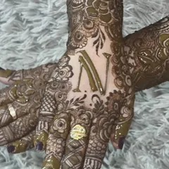 A semi-bridal design featuring the initial 'N' prominently on the back of the hand. It's a stylish way to add a personal touch.