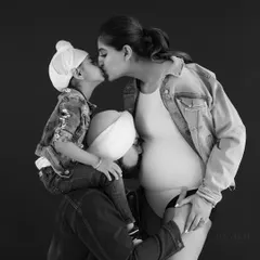 A beautiful black and white maternity portrait that doubles as a family photo, capturing the love and excitement of the whole family.