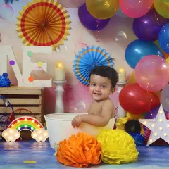 A happy smile from the tub! The rainbow-themed splash session is full of color and joy.