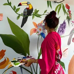 Here's a behind-the-scenes look at me working on the large tropical mural. It took about a week to complete, carefully painting each bird and leaf to bring the client's vision to life.