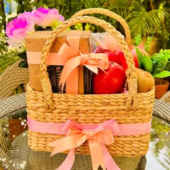 My modern take on a fresh fruit basket, combining health and indulgence. This hand-woven basket includes fresh apples and kiwis alongside a box of gourmet cookies, decorated with peach and pink ribbons for a soft, inviting look.