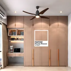 This bedroom showcases a full-wall wardrobe in "Mocha Mousse," Pantone's Color of the Year 2025. The design cleverly integrates a compact study desk and open shelving with backlighting.