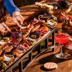 I present to you India's longest kebab, our 1.5-meter Adana Kebab. It’s more than a dish; it’s a spectacle of authentic Turkish grilling, meant for sharing and creating a truly dramatic dining moment.