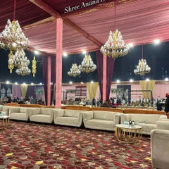 Plush white sofas arranged neatly under a canopy of crystal chandeliers, providing a luxurious and comfortable space for guests to relax.