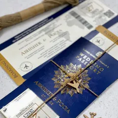 A passport invitation perfect for a destination wedding. This design features a boarding pass-style insert and is tied with jute rope and a small wooden airplane for a charming, travel-themed touch.