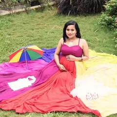 A lovely picnic setup featuring the rainbow maternity gown. The colorful trail is spread out, creating a vibrant and joyful scene with cute baby props.