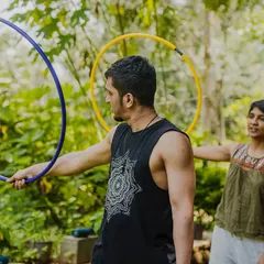 Here I am giving some pointers during a hoop workshop. I work with each person to help them get comfortable with the prop, whether it's learning a new trick or just getting the hoop to spin.