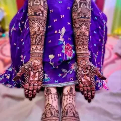 This full bridal package features matching Rajasthani palace and elephant designs on both hands and feet, creating a symmetrical and royal look.