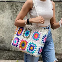 The sturdy crochet strap and roomy interior of our granny square tote make it both practical and beautiful. We use quality yarn to ensure it lasts.