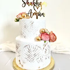 Simplicity is key for this two-tier wedding cake. I used a delicate lace stencil effect on the buttercream and adorned it with fresh roses and gold pearls for a timeless and romantic look.