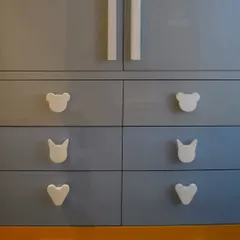 A close-up of the custom drawer knobs in the Casa Savera kids' room. We used fun shapes like bears, cats, and hearts to make the furniture more engaging for children.