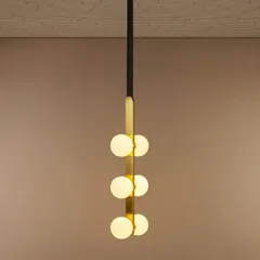 I love this pendant for its modern simplicity. The vertical arrangement of six opal globes on a sleek black and gold spine makes it a perfect lighting solution for stairwells, entryways, or rooms with high ceilings, providing a beautiful cascade of light.