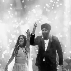 The energy of a grand entrance is electric. I captured this couple's joyous celebration, hands raised amidst a shower of cold pyro fireworks. This black and white candid shot freezes a moment of pure happiness and high energy, showcasing the lively spirit of a Punjabi wedding.
