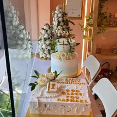 A glimpse of our Communion cake orders from a few Sundays back. This photo showcases a variety of designs, including a square cake with a rosary, a tiered cake with a cross, and croquembouche towers.