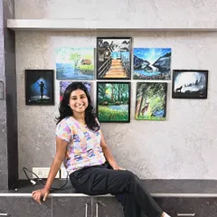 Here I am with some of my favorite early pieces. Each one represents a step in my growth as an artist. My passion for painting has made my life so colorful, and I cherish the lessons learned from every single attempt.