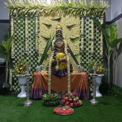 I specialize in decorations for religious festivals like Varamahalakshmi puja. This setup includes a backdrop of traditionally woven coconut leaves and a decorated mantap for the goddess.