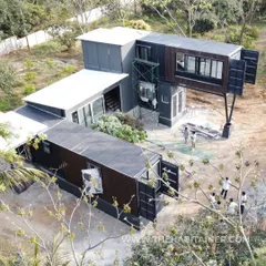 An aerial view of a complex container home during construction. This project showcases our ability to design and build multi-level, cantilevered structures by creatively stacking and arranging shipping containers.