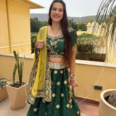 A happy client enjoying a destination wedding in my green and gold embroidered lehenga. It's lightweight, comfortable, and perfect for a daytime event.