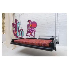 A side profile of the swing, showing how the two distinct, colorful art pieces serve as functional backrests, creating a dynamic and unconventional silhouette.