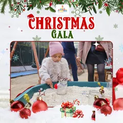 Christmas-themed sensory play is a wonderful way to engage the little ones. This toddler is exploring different textures in a bin filled with festive ornaments and materials.