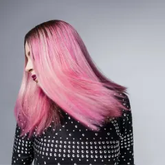 A shot from my work with musician Bianca Gomes of Shor Police. The movement in her vibrant pink hair is the focus, complemented by a studded black top that adds a bit of edge. This styling captures her dynamic energy as an artist.