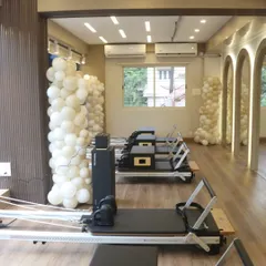 Our line of reformers waiting for the next session. We keep our studio pristine and ready for you to get the best workout.
