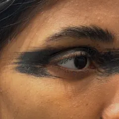 A close-up of a bold, smudged eyeliner look paired with strong soap brows. This is a raw, edgy style perfect for fashion-forward editorials.
