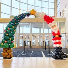 Talk about a grand entrance! We had so much fun creating this unique Christmas balloon arch, shaped like a Christmas tree flowing into Santa Claus. This large scale balloon sculpture is a super fun way to welcome guests and employees. 🎉