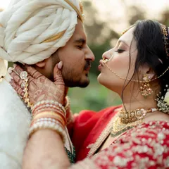 An intimate close-up of the bride giving the groom a playful and affectionate kiss. This shot is all about the small, tender gestures that speak volumes, capturing the deep connection and love between the couple.