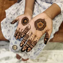 A minimalist design featuring a single floral mandala in the center of each palm. The fingers are decorated with simple bands and leaf patterns.