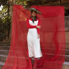 From the 'LUNA' series, this look plays with bold color blocking and exaggerated accessories. The oversized, hand-painted sombrero and vibrant red elements against a white dress create a surreal, folk-art-inspired aesthetic.