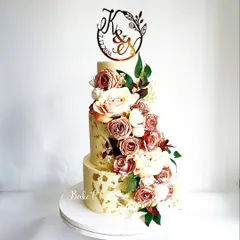 For moments that call for sheer elegance, this three-tier wedding cake is a perfect choice. This 6kg Belgian chocolate truffle cake features a cascade of dusty rose and cream flowers, creating a timeless centerpiece for a couple's special day.