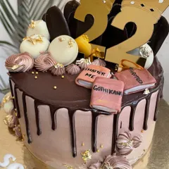 A slice of story and a chapter of sweetness. This chocolate drip cake was designed for a 22nd birthday, complete with crowns and favorite book titles.