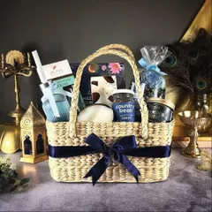 Our "Grand Galore" hamper is a luxurious basket filled with blue-themed items, including a diffuser, gourmet coffee, and premium chocolates.