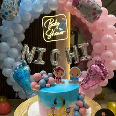 A perfect setup for a baby shower or gender reveal party. This design features a full balloon ring in pink and blue, a custom "Baby Shower" neon sign, and a matching cake, creating a beautiful focal point for the celebration.