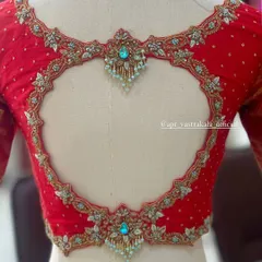 The craftsmanship of the heart-shaped cutout is evident in this close-up, showing the delicate beadwork and fine embroidery.