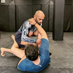 Working for a submission during a grappling session. Every grip and every shift in weight matters in the ground game.